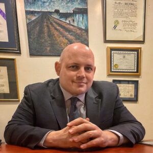 Peter Barta sitting at a desk